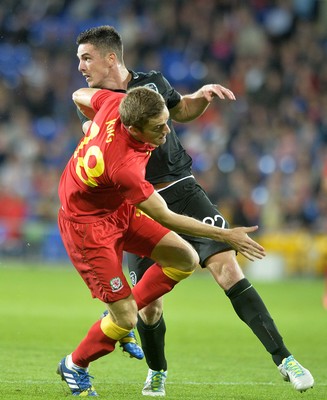 140813 - Wales v Republic of Ireland, International Friendly -  Andy King of Wales, left, battles for the ball with Ciaran Clark of Ireland