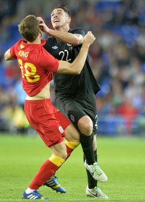 140813 - Wales v Republic of Ireland, International Friendly -  Andy King of Wales, left, battles for the ball with Ciaran Clark of Ireland