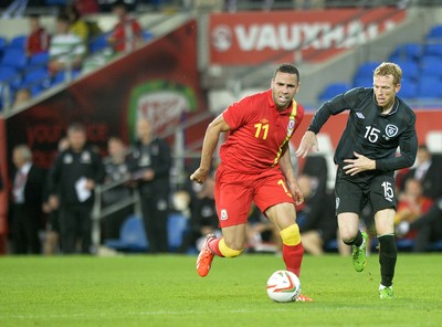 140813 - Wales v Republic of Ireland, International Friendly -  Hal Robson Kanu of Wales, left, is tackled by Paul Green of Ireland