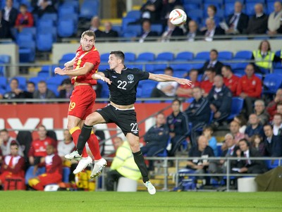 140813 - Wales v Republic of Ireland, International Friendly -  Sam Vokes of Wales, left, flicks the ball past the challenge by Ciaran Clark of Ireland