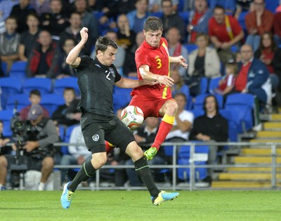 140813 - Wales v Republic of Ireland, International Friendly -  Ben Davies of Wales, right, is tackled by Seamus Coleman of Ireland
