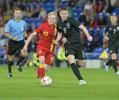 140813 - Wales v Republic of Ireland, International Friendly -  Jonathan Williams of Wales, left, is tackled by James McCarthy of Ireland