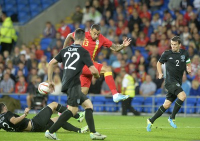 140813 - Wales v Republic of Ireland, International Friendly -  Craig Davies of Wales has his shot blocked by Marc Wilson of Ireland
