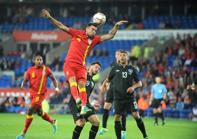 140813 - Wales v Republic of Ireland, International Friendly -  Joe Ledley of Wales beats Shane Long of Ireland