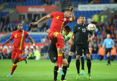 140813 - Wales v Republic of Ireland, International Friendly -  Joe Ledley of Wales beats Shane Long of Ireland