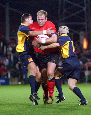 1-11-02 Wales v Romania  (Wrexham, The Racecourse)Wales' Scott Quinnell is held by Romeo Gontineac (rt) and Florin Corodeanu (left)