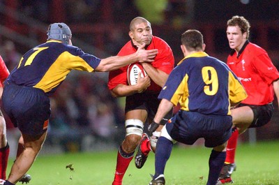 1-11-02 Wales v Romania  (Wrexham, The Racecourse)Wales' Colin Charvis is caught by Alin Petrache (lft) and Petre Mitu (rt)