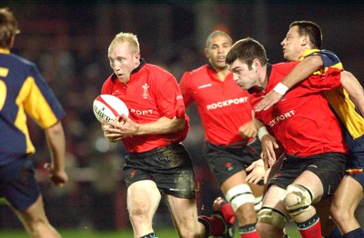 1-11-02 Wales v Romania  (Wrexham, The Racecourse)Wales' Tom Shanklyn advances with ball as Michael Owen is held off