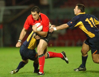 011102  Wales v RomaniaWales Sonny Parker beats tackle by Ionut Tofan and Marius Picoiu