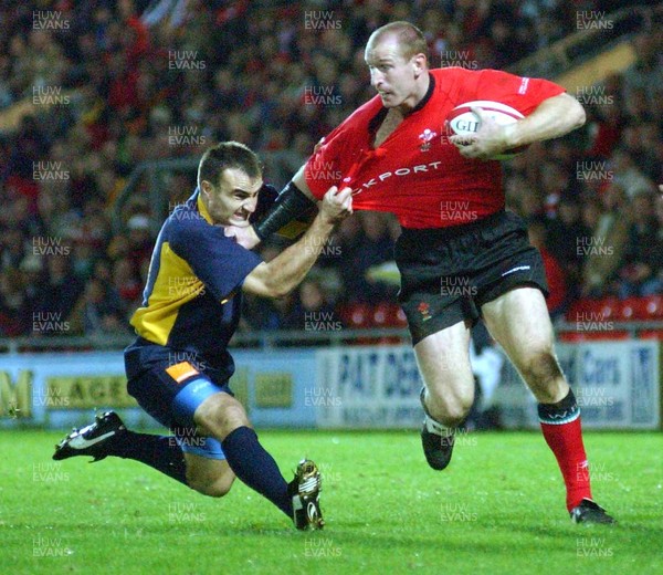 1-11-02 Wales v Romania  (Wrexham, The Racecourse)Wales' Gareth Thomas is dragged down by Petre Mitu