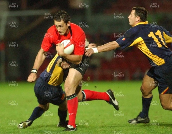 011102  Wales v RomaniaWales Sonny Parker beats tackle by Ionut Tofan and Marius Picoiu