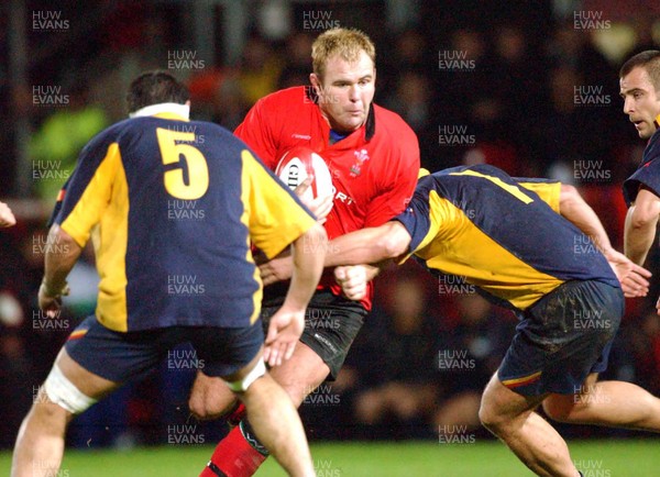 1-11-02 Wales v Romania  (Wrexham, The Racecourse)Wales' Scott Quinnell charges as tacklers Christian Petre (left) and Alin Petrache (rt) close