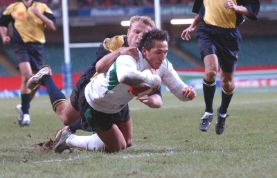 12-11-04. Wales v Romania.  Wales' Gavin Henson dives over to score try despite tackle from Vasile Ghioc  
