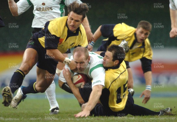 12-11-04. Wales v Romania.  Wales' Gareth Thomas is caught by Valentin Mafti (rt)  