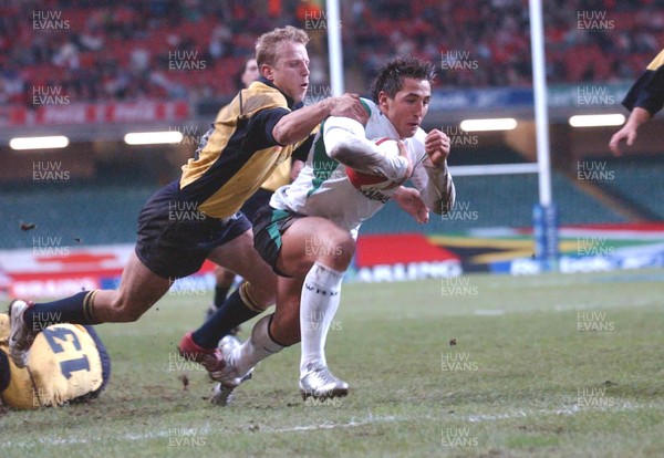 12-11-04. Wales v Romania.  Wales' Gavin Henson dives over to score try despite tackle from Vasile Ghioc  