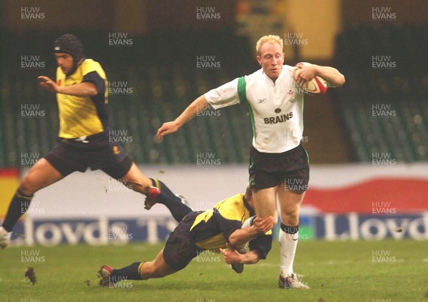 12.11.04 Wales v Romania  Wales Tom Shanklin beats tackle by Vasile Ghioc  