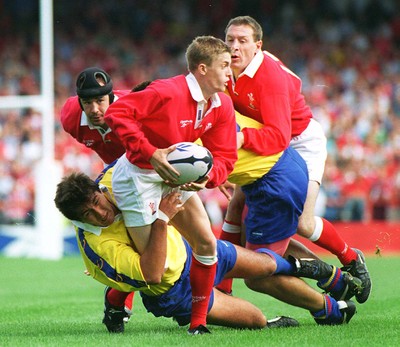 300897 - Wales v Romania - Arwel Thomas is tackled by Valentin Maftei