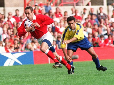 300897 - Wales v Romania - Wayne Proctor of Wales gets past Ionel Rotaru