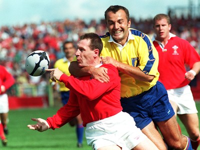 300897 - Wales v Romania - Allan Bateman of Wales is tackled by Gheorghe Solomie