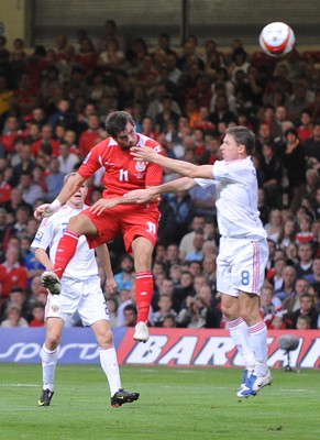 09.09.09 - World Cup Qualifying Group 4 Wales v Russia Wales' Joe Ledley beats Russia's Igor Semshov to a high ball 