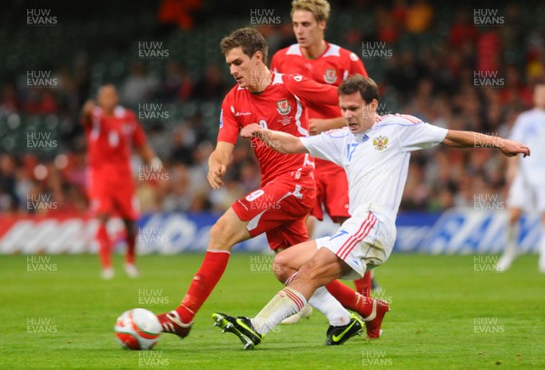 09.09.09 - World Cup Qualifying Group 4 Wales v Russia Wales' Aaron Ramsey is tackled by Russia's Konstantin Zyryanov  