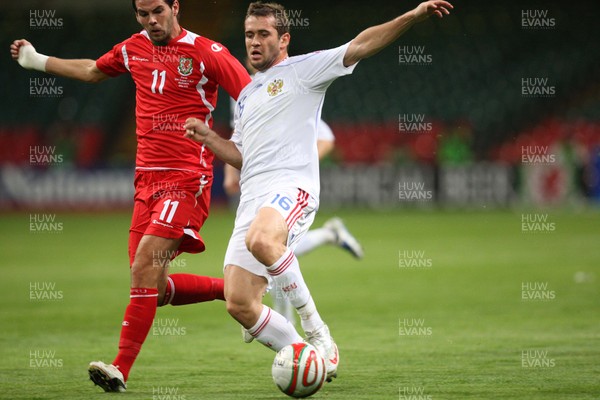 09.09.09 Wales v Russia... Russia's Alexander Kerzhakov taking on Wales' Joe Ledley . 