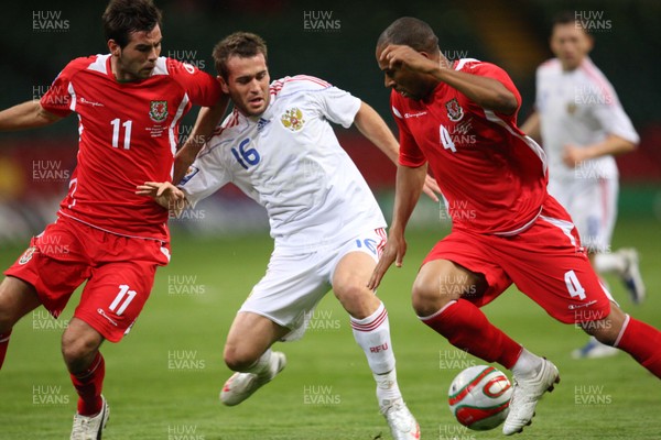 09.09.09 Wales v Russia... Russia's Alexander Kerzhakov being challenged by  Wales' Joe Ledley (L) and  Danny Gabbidon . 