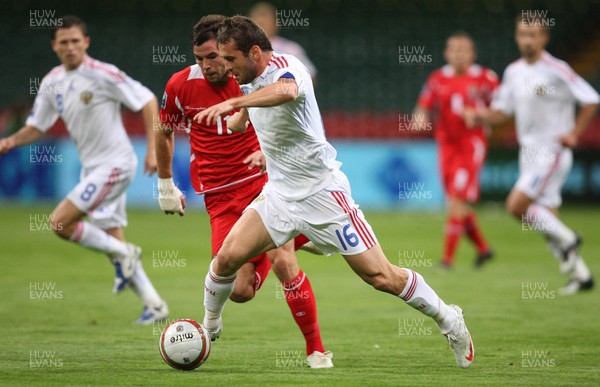 09.09.09 Wales v Russia... Russia's Alexander Kerzhakov taking on Wales' Joe Ledley . 