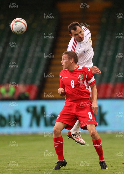09.09.09 Wales v Russia... Russia's Sergei Ignashevich climbing above Wales' Craig Bellamy . 