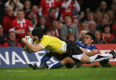 13.11.09 Wales v Samoa... Wales' Leigh Halfpenny scores try despite tackle by Samoa's David Lemi. 