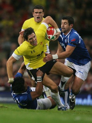 13.11.09 Wales v Samoa... Wales' James Hook is tackled by  Samoa's Seilala Mapusua and  Gavin Williams. 