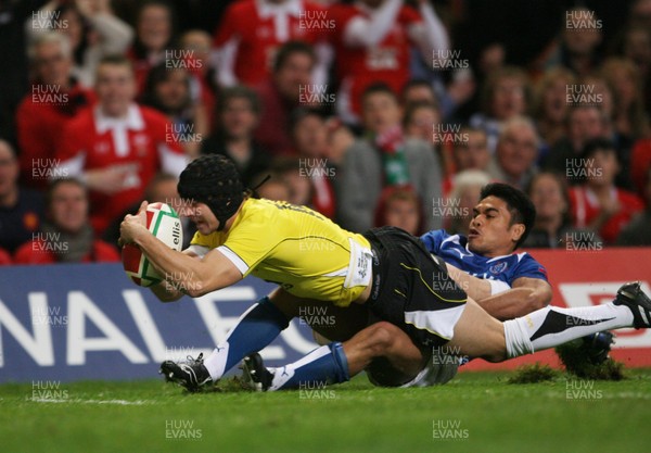 13.11.09 Wales v Samoa... Wales' Leigh Halfpenny scores try despite tackle by Samoa's David Lemi. 