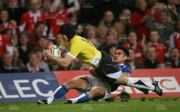 13.11.09 Wales v Samoa... Wales' Leigh Halfpenny scores try despite tackle by Samoa's David Lemi. 