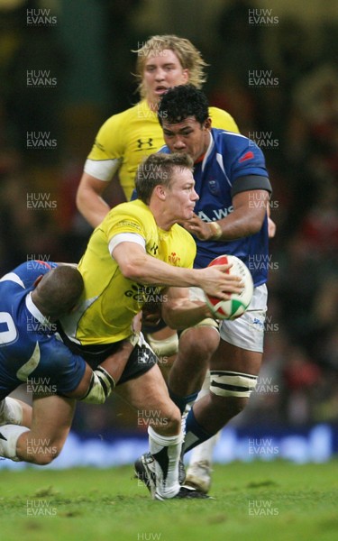 13.11.09 Wales v Samoa... Wales' Dwayne Peel is tackled by Samoa's Junior Poluleuligaga.. 