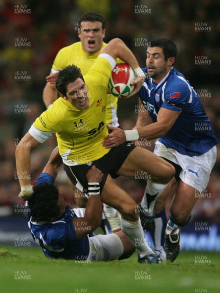 13.11.09 Wales v Samoa... Wales' James Hook is tackled by  Samoa's Seilala Mapusua and  Gavin Williams. 