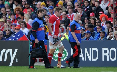 18.09.11 - Wales v Samoa - Rugby World Cup 2011 - Dan Lydiate of Wales leaves the field with physio Mark Davies(L) and team doctor Prof John Williams. 