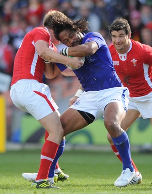 18.09.11 - Wales v Samoa - Rugby World Cup 2011 - Seilala Mapusua of Samoa is tackled by Rhys Priestland of Wales. 