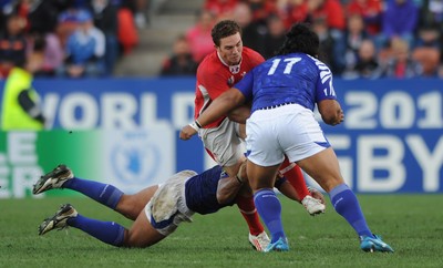 18.09.11 - Wales v Samoa - Rugby World Cup 2011 - George North of Wales is tackled by Maurie Faasavalu of Samoa. 