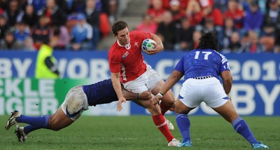 18.09.11 - Wales v Samoa - Rugby World Cup 2011 - George North of Wales is tackled by Maurie Faasavalu of Samoa. 