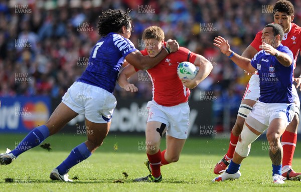 18.09.11 - Wales v Samoa - Rugby World Cup 2011 - Rhys Priestland of Wales is tackled by Maurie Faasavalu of Samoa. 