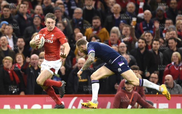030218 - Wales v Scotland - NatWest 6 Nations 2018 - Josh Adams of Wales is tackled by Byron McGuigan of Scotland