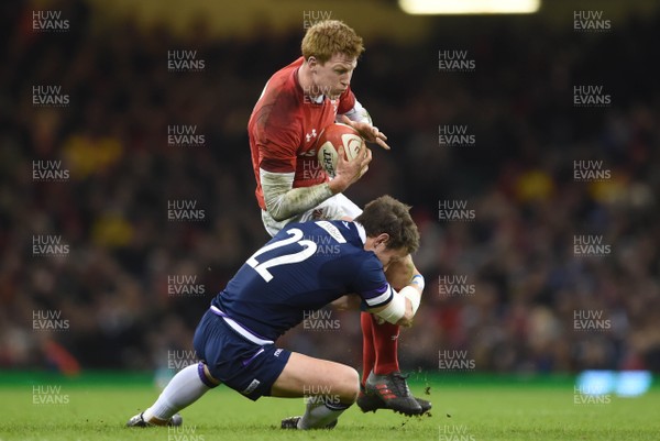 030218 - Wales v Scotland - NatWest 6 Nations 2018 - Rhys Patchell of Wales is tackled by Pete Horne of Scotland
