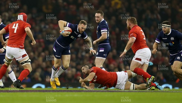 030218 - Wales v Scotland - Natwest 6 Nations - Byron McGuigan of Scotland is tackled by Josh Navidi of Wales