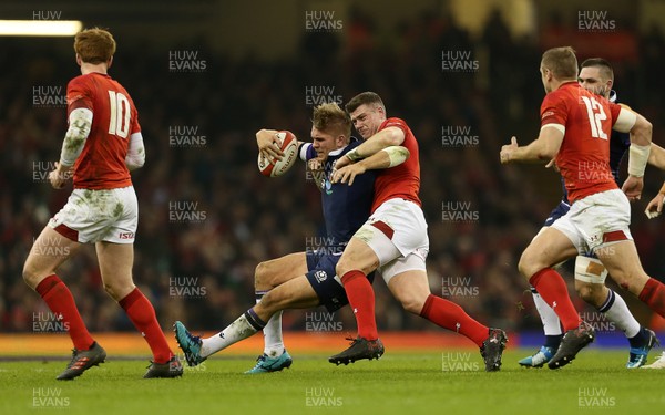 030218 - Wales v Scotland - Natwest 6 Nations - Chris Harris of Scotland is tackled by Scott Williams of Wales