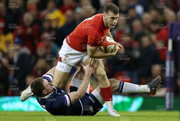 030218 - Wales v Scotland - Natwest 6 Nations - Gareth Davies of Wales is tackled by Stuart Hogg of Scotland