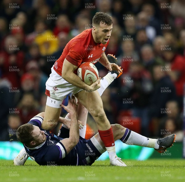 030218 - Wales v Scotland - Natwest 6 Nations - Gareth Davies of Wales is tackled by Stuart Hogg of Scotland