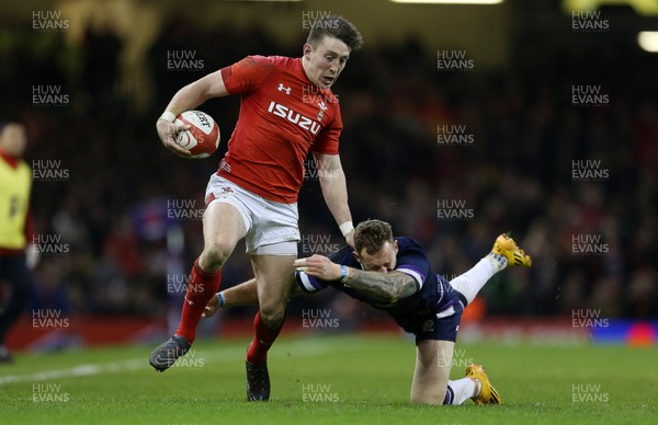 030218 - Wales v Scotland - Natwest 6 Nations - Josh Adams of Wales is tackled by Byron McGuigan of Scotland