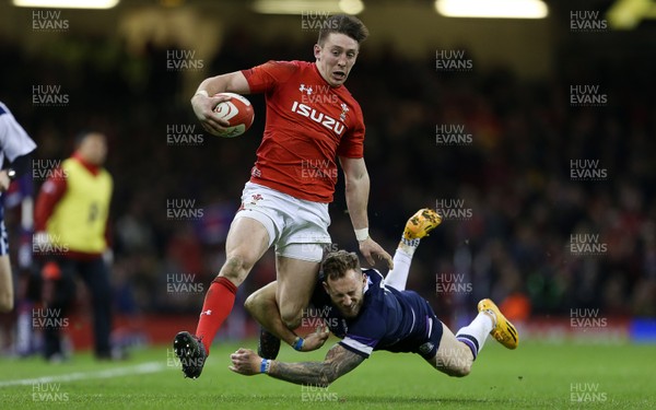 030218 - Wales v Scotland - Natwest 6 Nations - Josh Adams of Wales is tackled by Byron McGuigan of Scotland