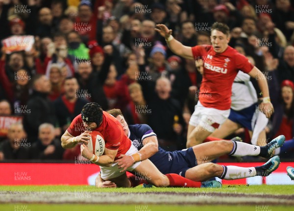 030218 - Wales v Scotland, NatWest 6 Nations - Leigh Halfpenny of Wales beats Huw Jones of Scotland as he powers over to score try