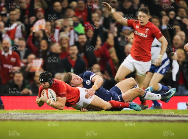 030218 - Wales v Scotland, NatWest 6 Nations - Leigh Halfpenny of Wales beats Huw Jones of Scotland as he powers over to score try